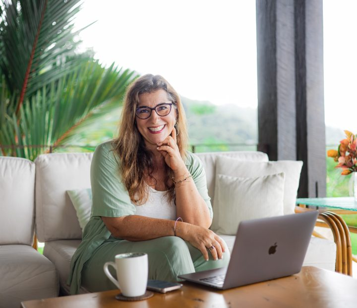 Ana Montesino working on a terrace surrounded by tropical greenery